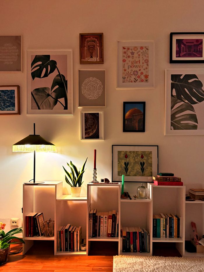 Warm and inviting living room featuring artistic wall decor and modern bookshelf.